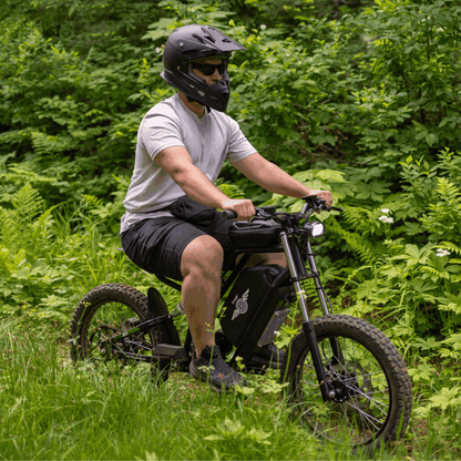 Person riding a Nova 3 mountain bike through a forest