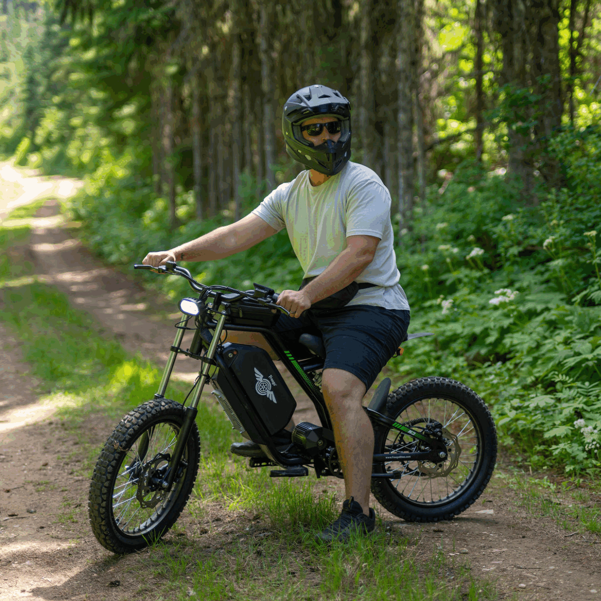 Man riding a Freego Nova 3 electric bike on a forest path