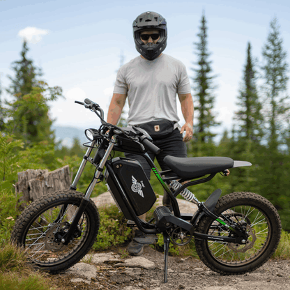 Person on a Nova 3 dirt bike in a forest setting